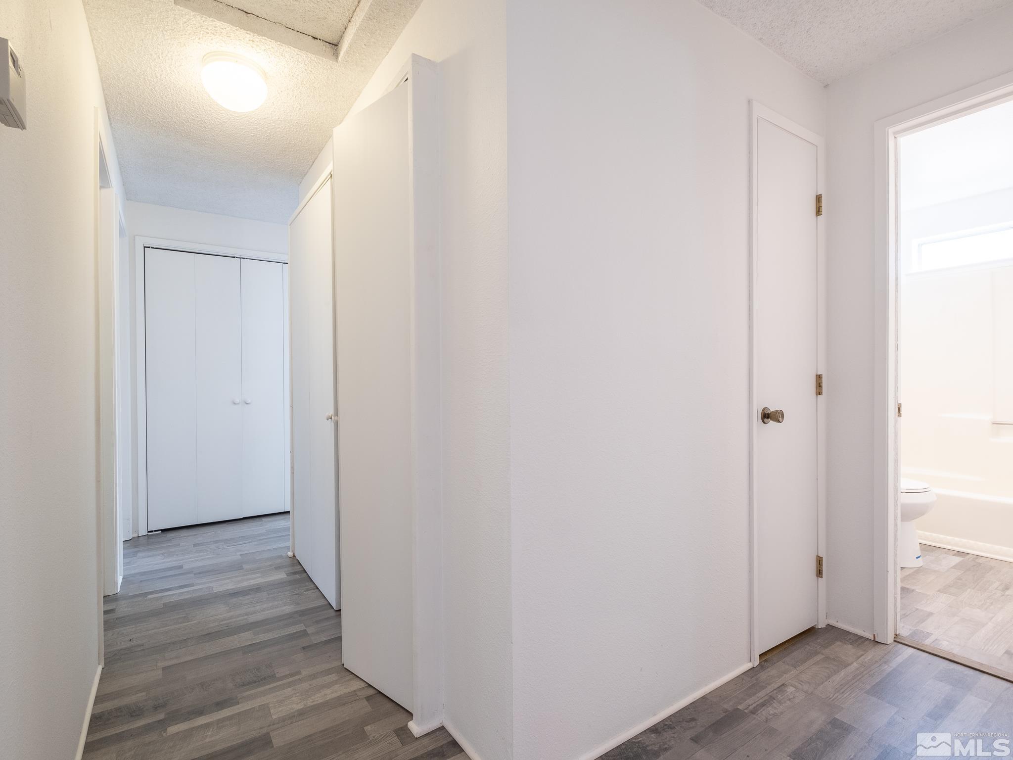 15025 Perlite Drive Reno, NV 89521 - Photo 9 of 24 a view of a hallway with wooden floor