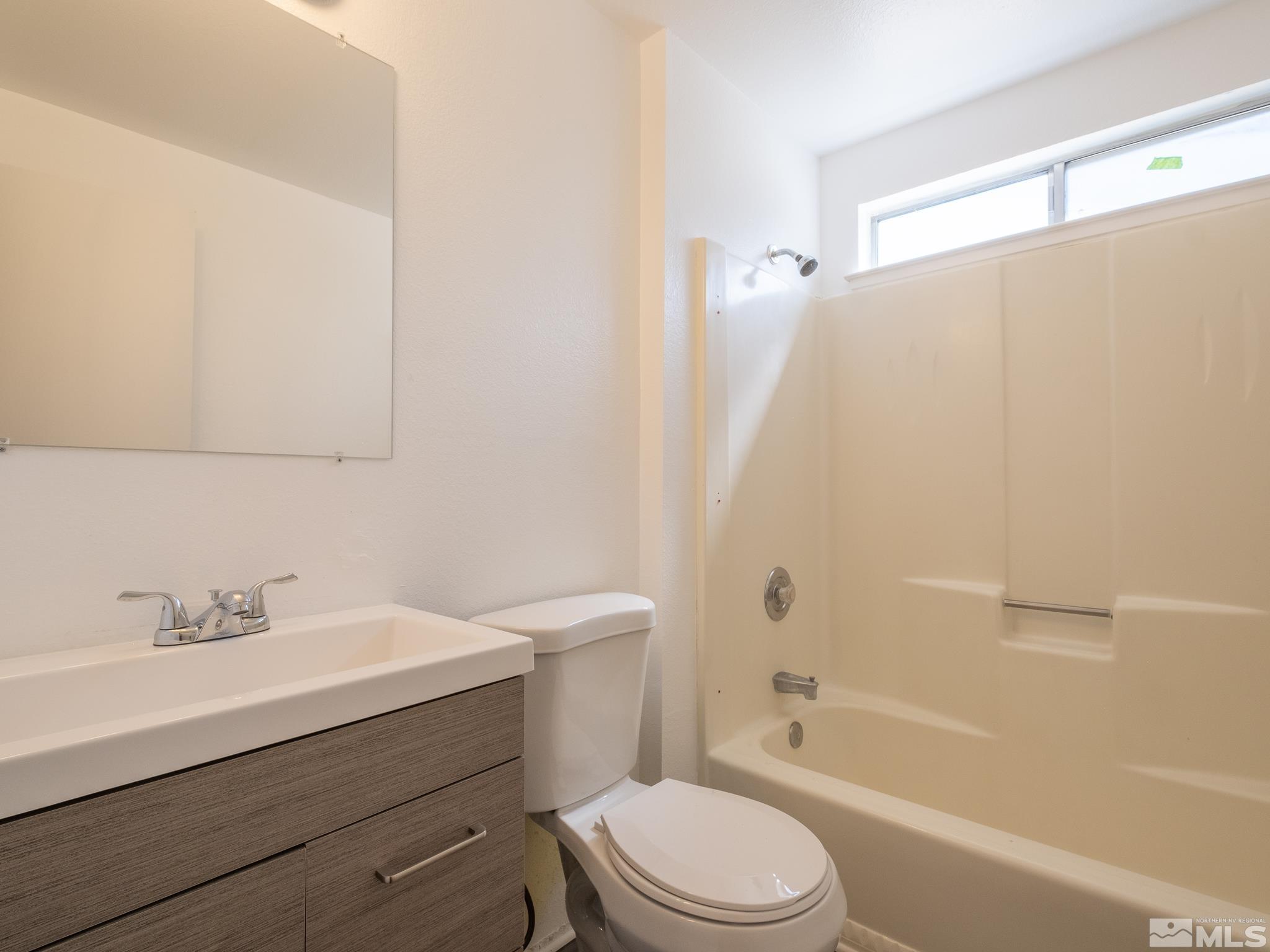 15025 Perlite Drive Reno, NV 89521 - Photo 10 of 24 a bathroom with a sink a toilet and shower