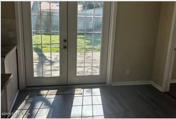 a view of an empty room with glass door