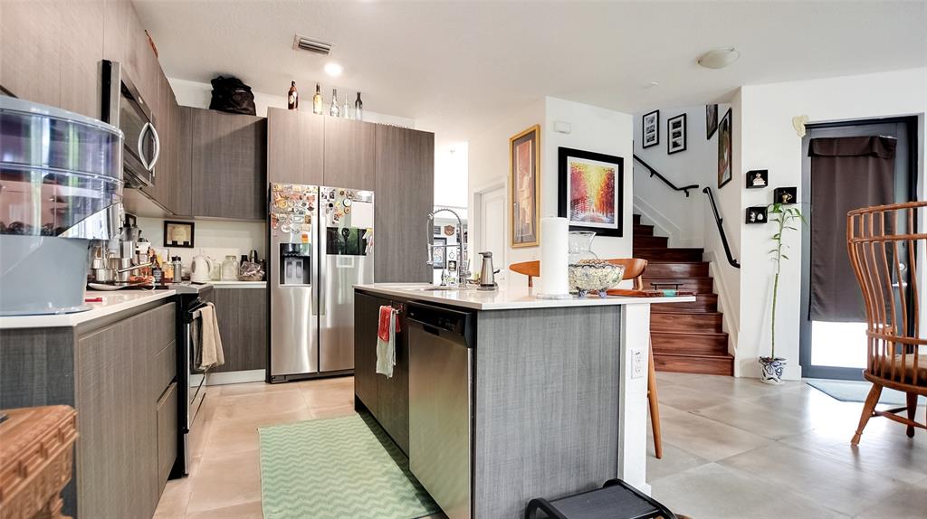 542 Southwest 91st Court, Unit 542 Miami, FL 33174 - Photo 4 of 33 a kitchen with stainless steel appliances lots of counter top space and cabinets