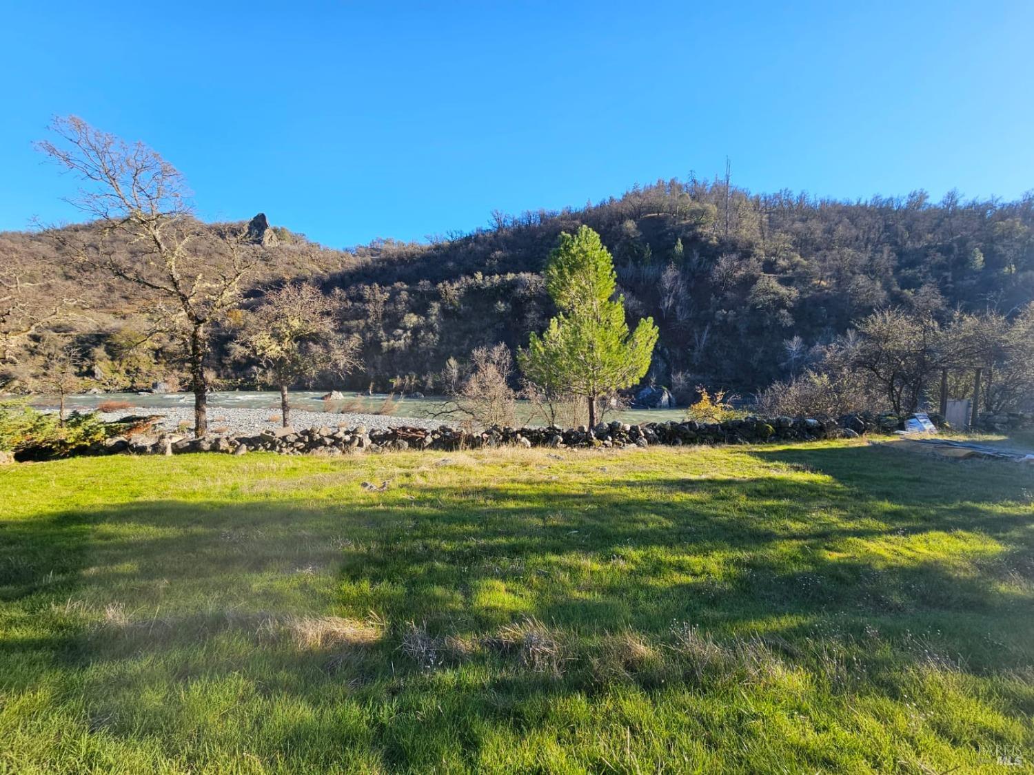 32333 Mendocino Pass Road Covelo, CA 95428 - Photo 11 of 22 a view of a water pond with green yard