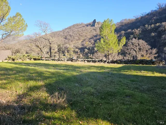 a view of a field with a building in background