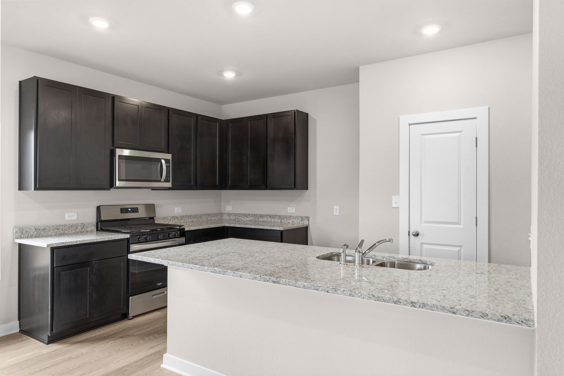 25517 Ashton Look Drive Elgin, TX 78621 - Photo 11 of 34 a kitchen with stainless steel appliances granite countertop a sink and a stove