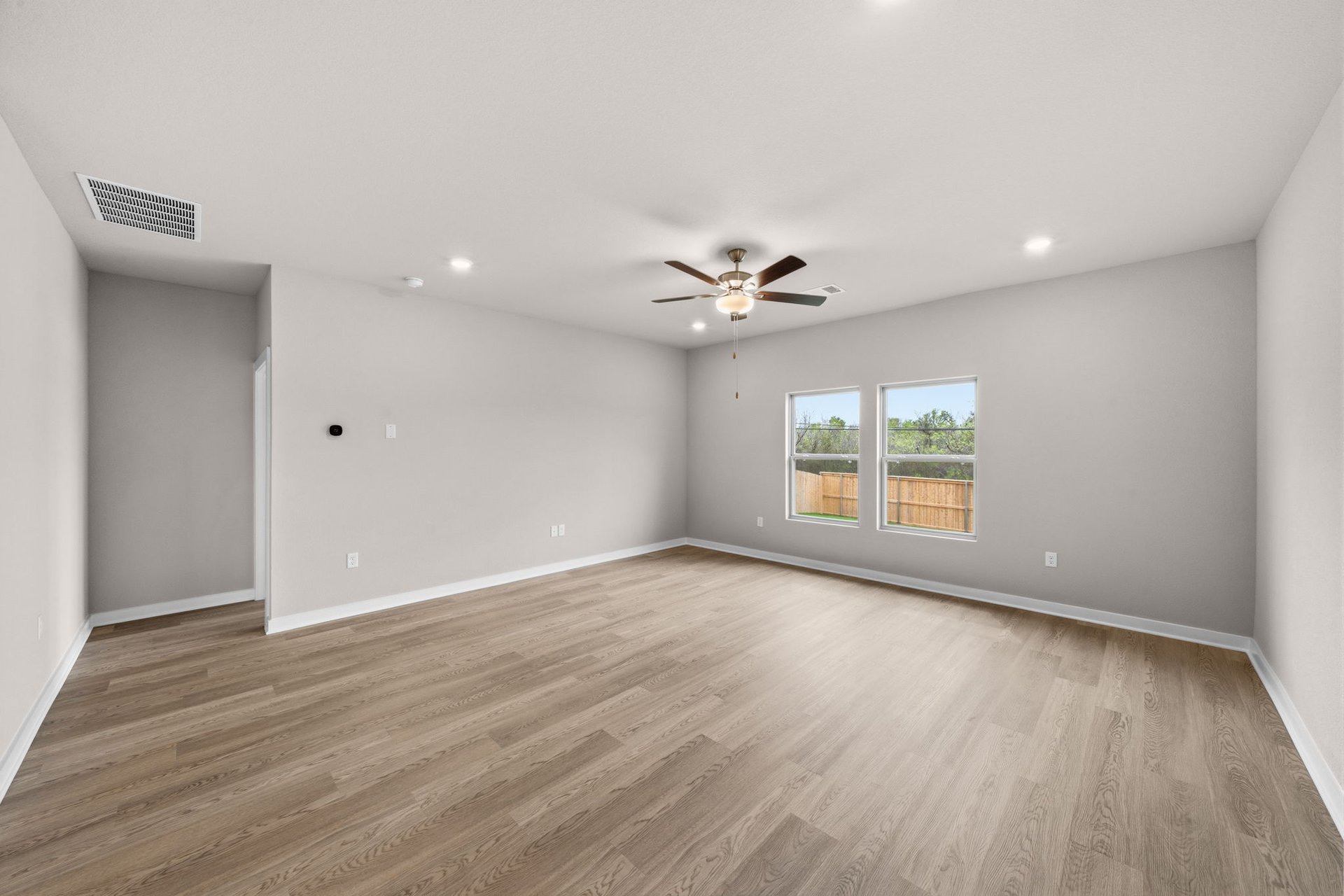 25517 Ashton Look Drive Elgin, TX 78621 - Photo 15 of 34 a view of an empty room with wooden floor and a window