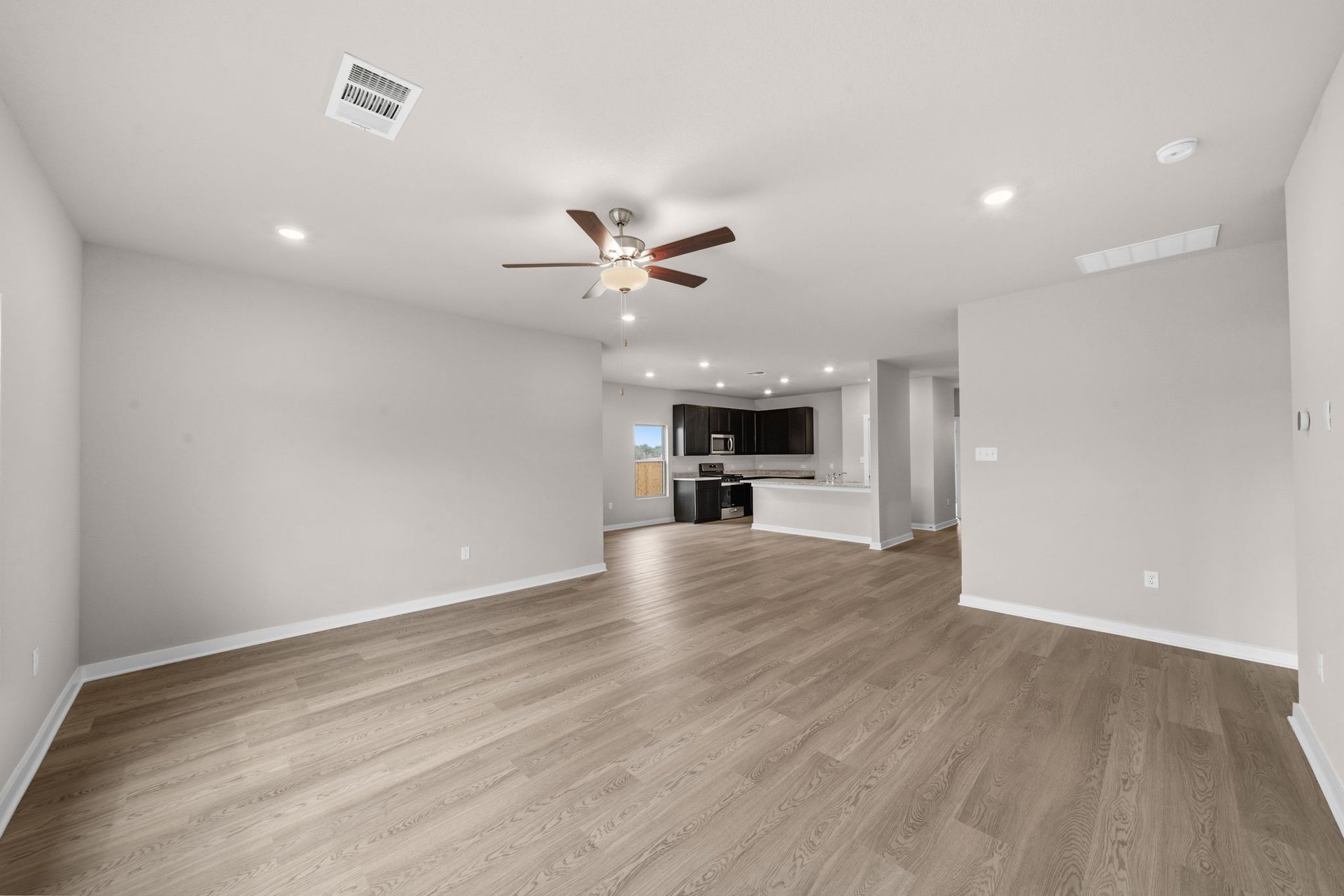 25517 Ashton Look Drive Elgin, TX 78621 - Photo 16 of 34 a view of empty room with wooden floor and a ceiling fan