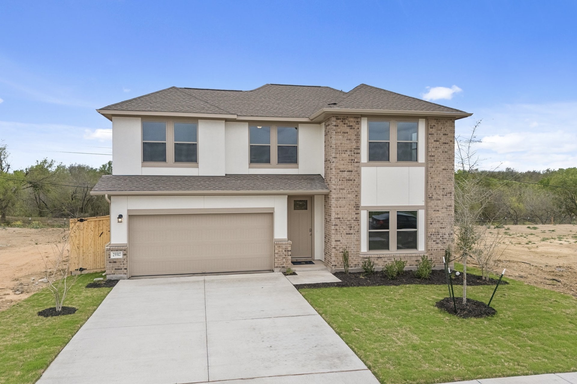 25517 Ashton Look Drive Elgin, TX 78621 - Photo 2 of 34 a front view of a house with a yard and garage