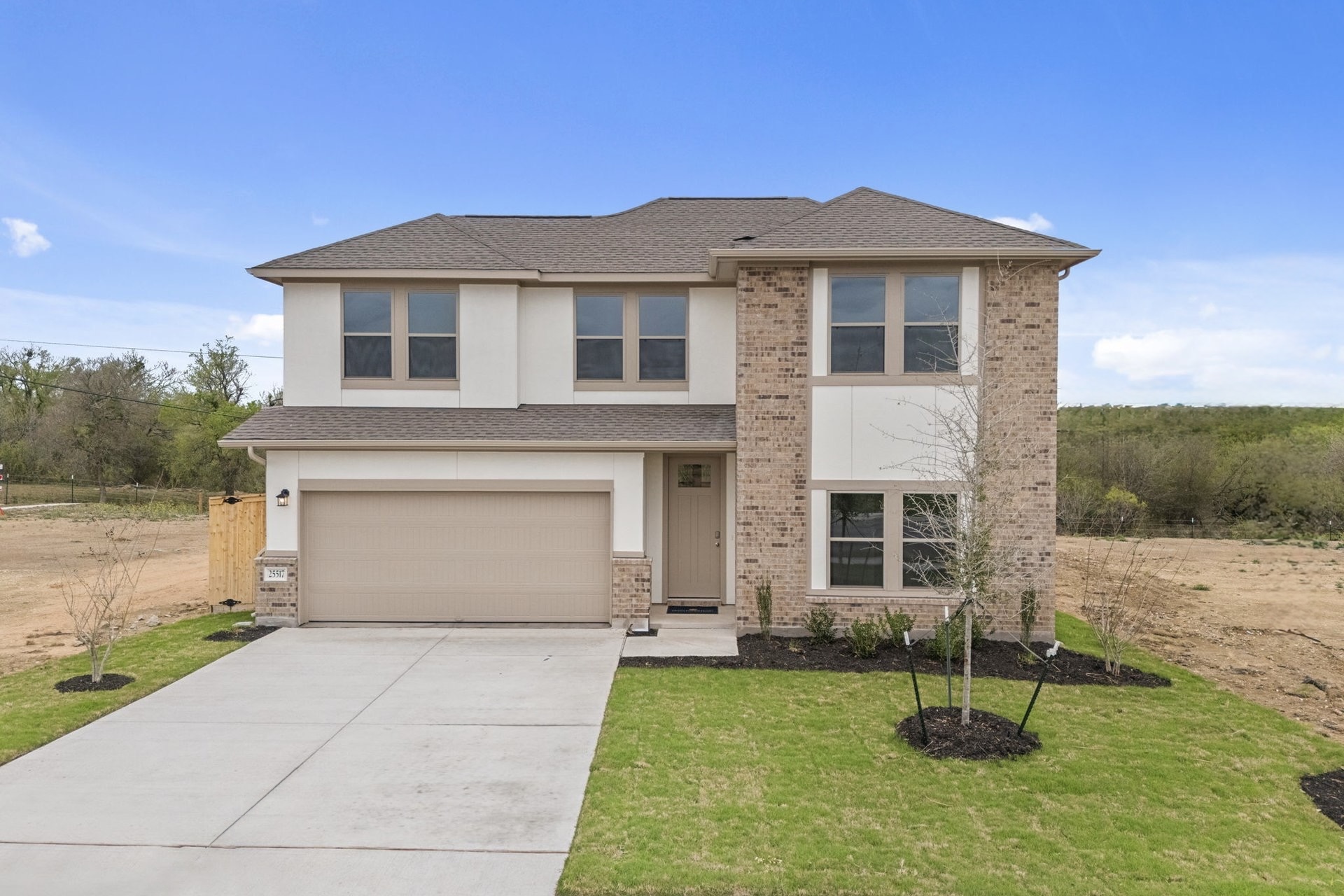 25517 Ashton Look Drive Elgin, TX 78621 - Photo 3 of 34 a front view of a house with a yard and garage