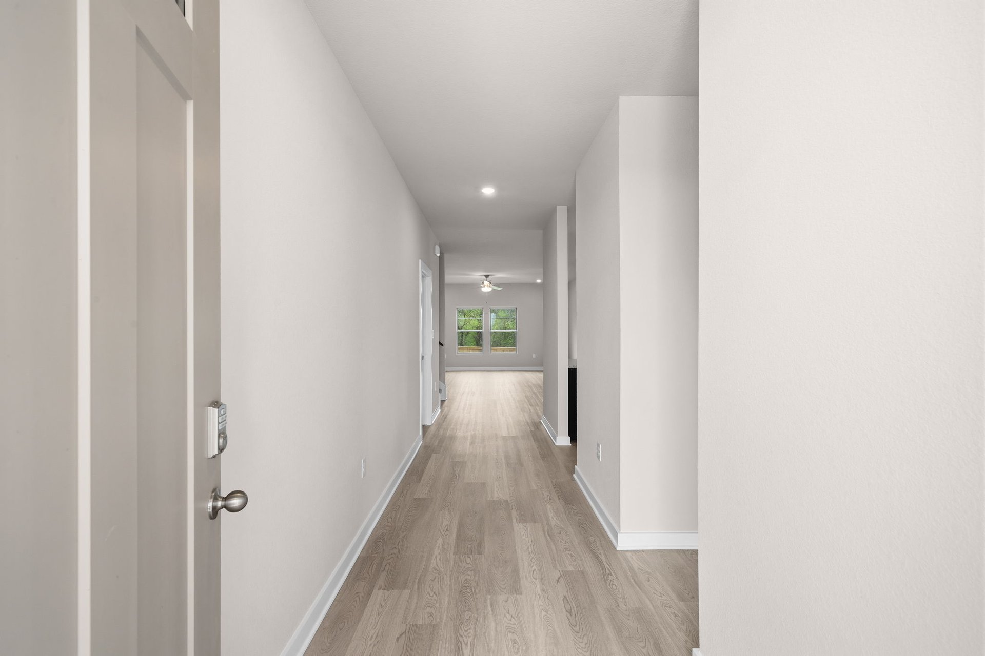 25517 Ashton Look Drive Elgin, TX 78621 - Photo 5 of 34 a view of a hallway with wooden floor
