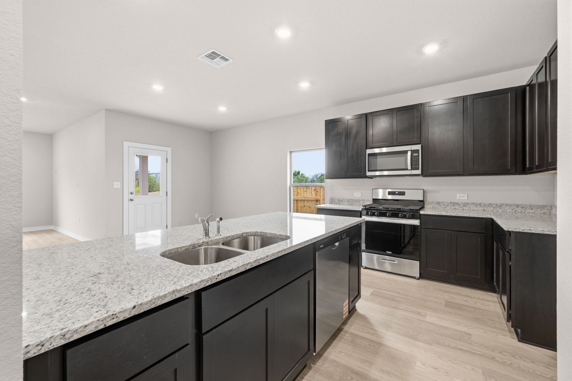 25517 Ashton Look Drive Elgin, TX 78621 - Photo 7 of 34 a kitchen with stainless steel appliances granite countertop a sink and a stove