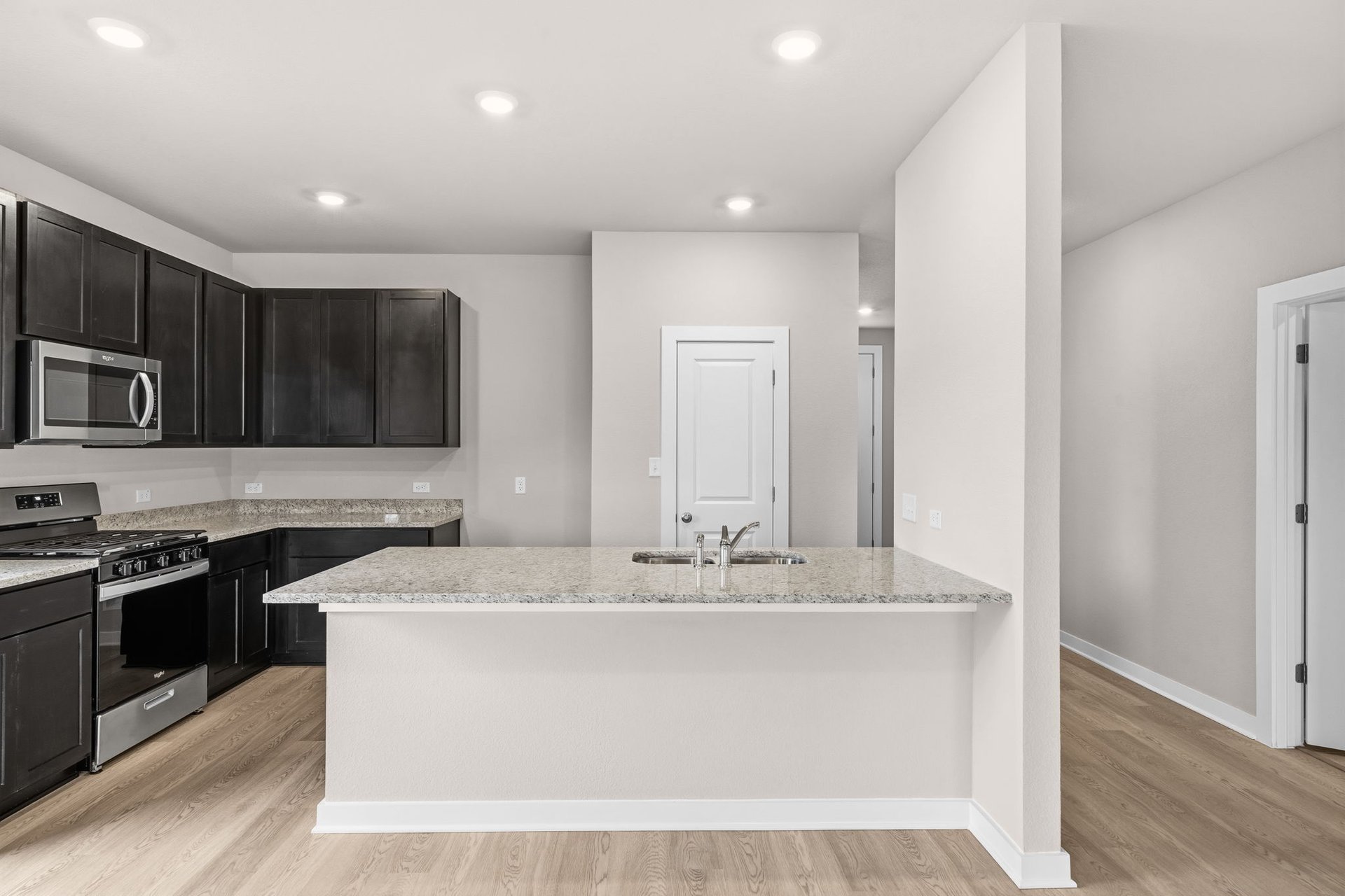 25517 Ashton Look Drive Elgin, TX 78621 - Photo 8 of 34 a view of a kitchen with stainless steel appliances granite countertop a stove a sink and a microwave