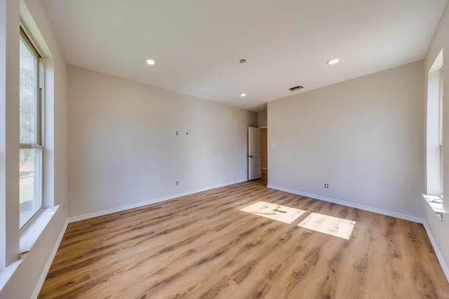 a view of an empty room and wooden floor