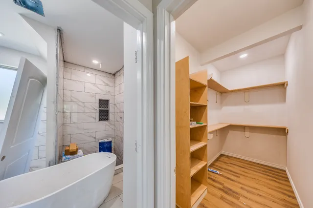 a bathroom with a bathtub and a shower