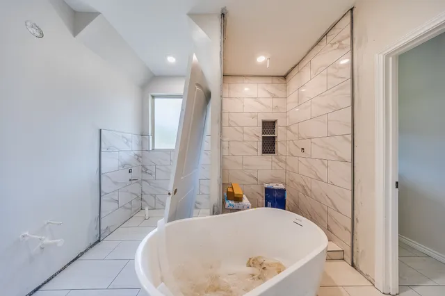 a bathroom with a bathtub and shower