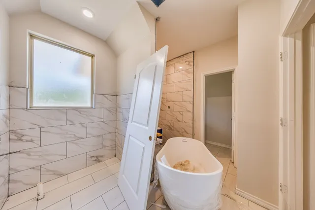 a bathroom with a toilet and a bathtub
