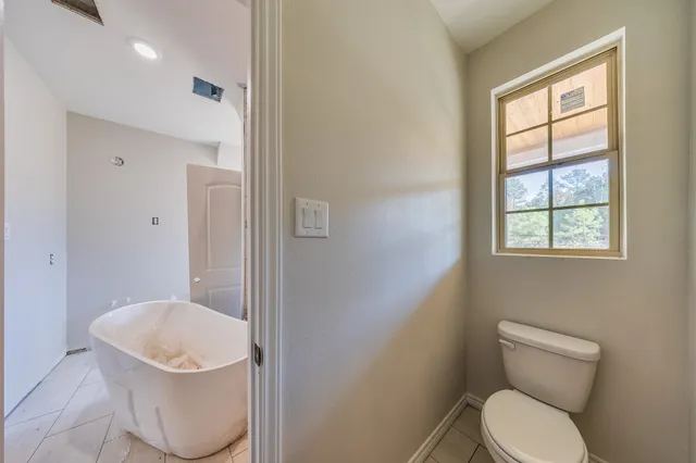 a white toilet sitting next to a bathroom sink