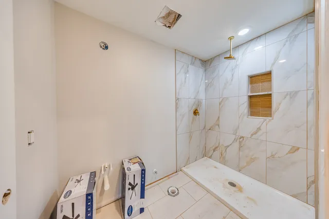 a bathroom with a bathtub and shower