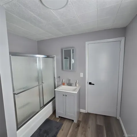 a bathroom with a sink mirror toilet and shower