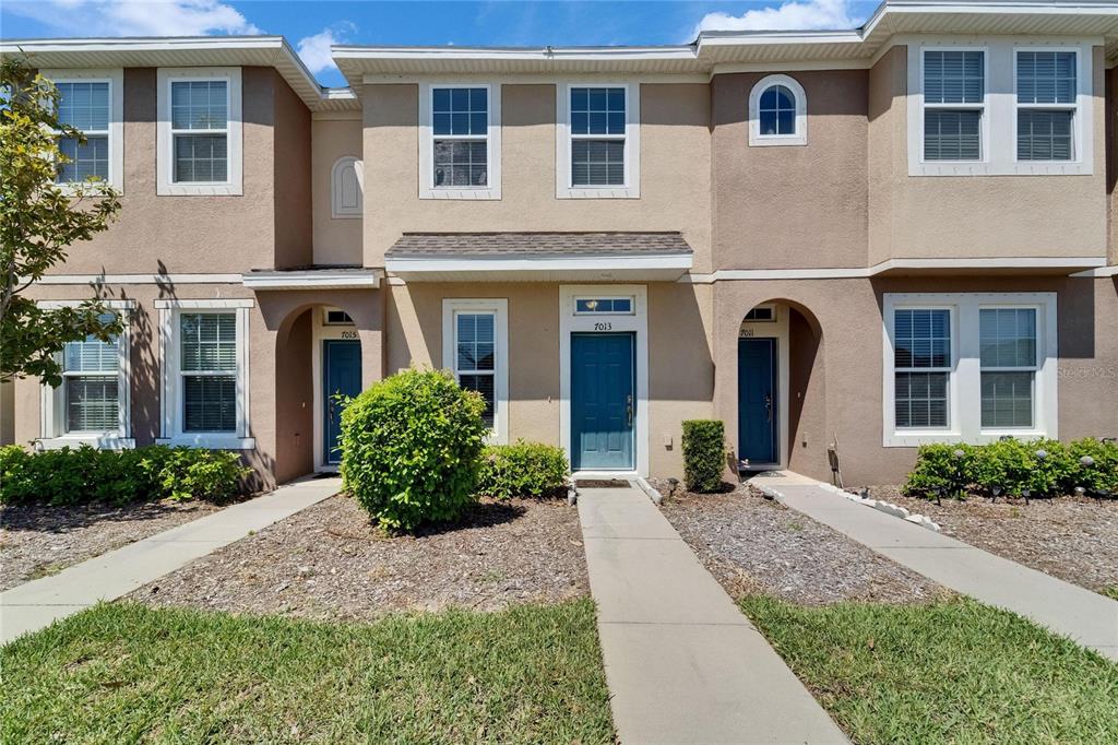 a front view of a house with garden