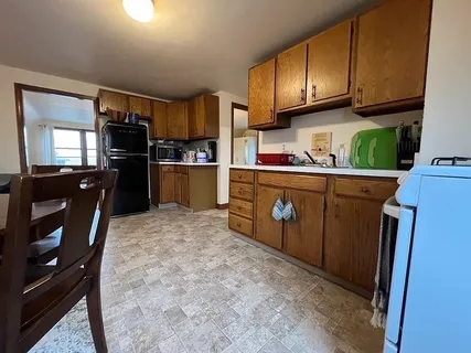 a kitchen with stainless steel appliances granite countertop a refrigerator a stove top oven a sink and dishwasher
