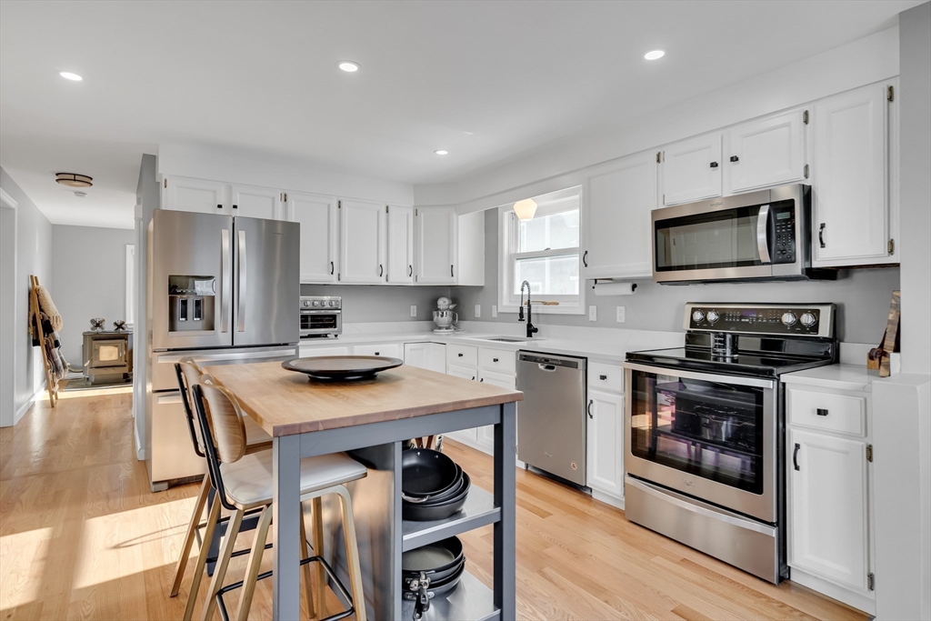 7 Long Terrace Boston, MA 02132 - Photo 17 of 42 a kitchen with stainless steel appliances a stove a sink a microwave a refrigerator and cabinets