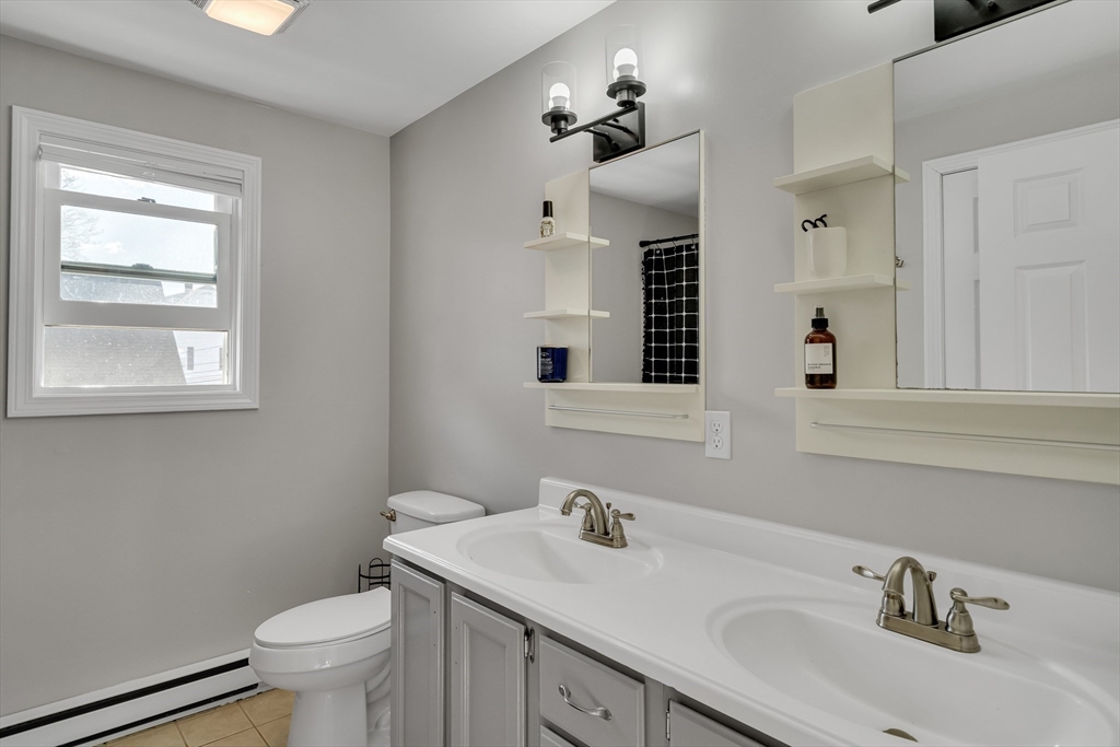 7 Long Terrace Boston, MA 02132 - Photo 31 of 42 a bathroom with a toilet sink and mirror