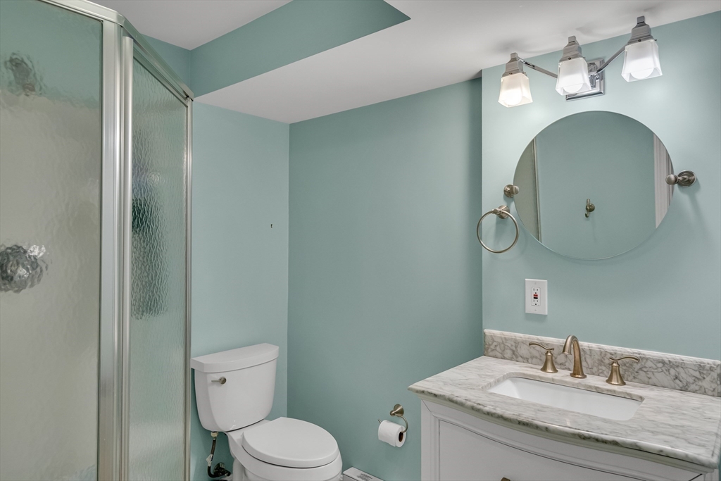 7 Long Terrace Boston, MA 02132 - Photo 35 of 42 a bathroom with a granite countertop toilet sink and mirror