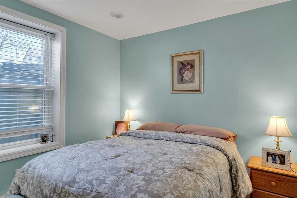 7 Long Terrace Boston, MA 02132 - Photo 37 of 42 a bedroom with a bed and a lamp on dresser next to a window