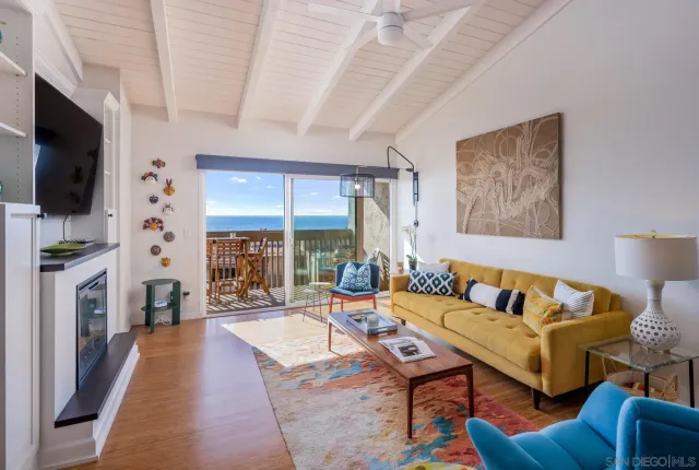 a view of a white house with a outdoor space and sitting space