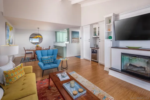 a view of a dining room with furniture a chandelier and wooden floor