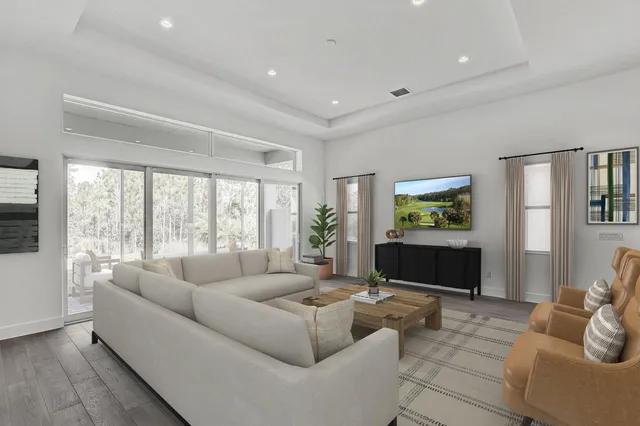 a living room with furniture a large window and a flat screen tv