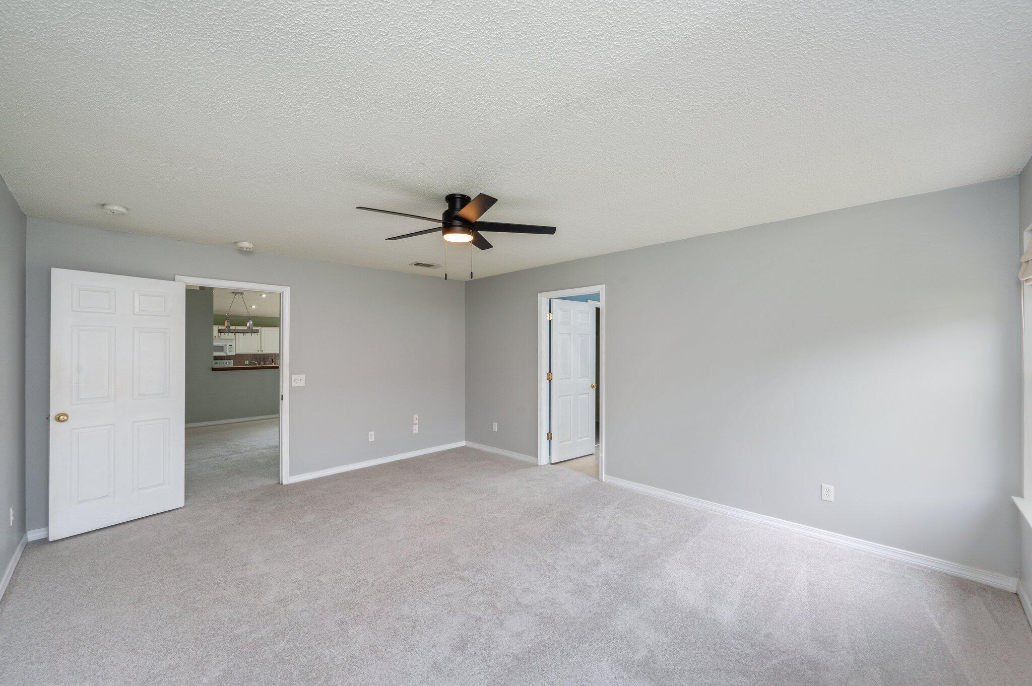 488 Jillian Drive Crestview, FL 32536 - Photo 18 of 29 a view of an empty room with a ceiling fan