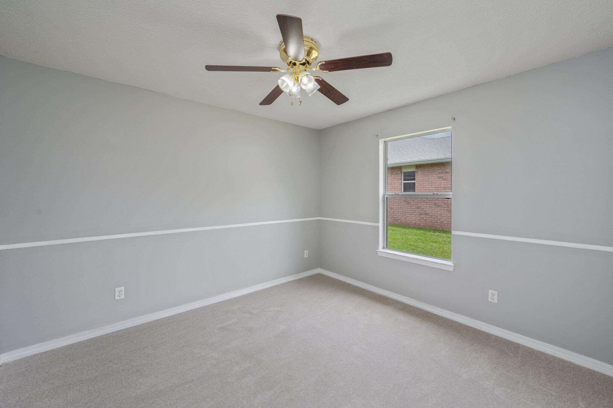 488 Jillian Drive Crestview, FL 32536 - Photo 20 of 29 an empty room with ceiling fan and window