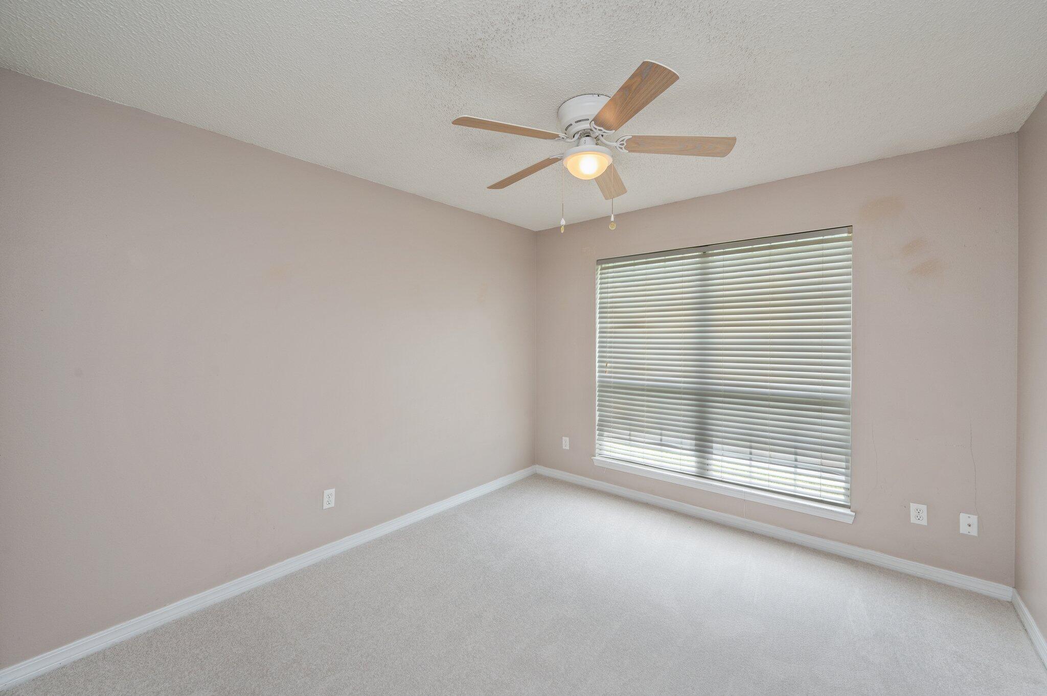 488 Jillian Drive Crestview, FL 32536 - Photo 21 of 29 an empty room with a window and ceiling fan