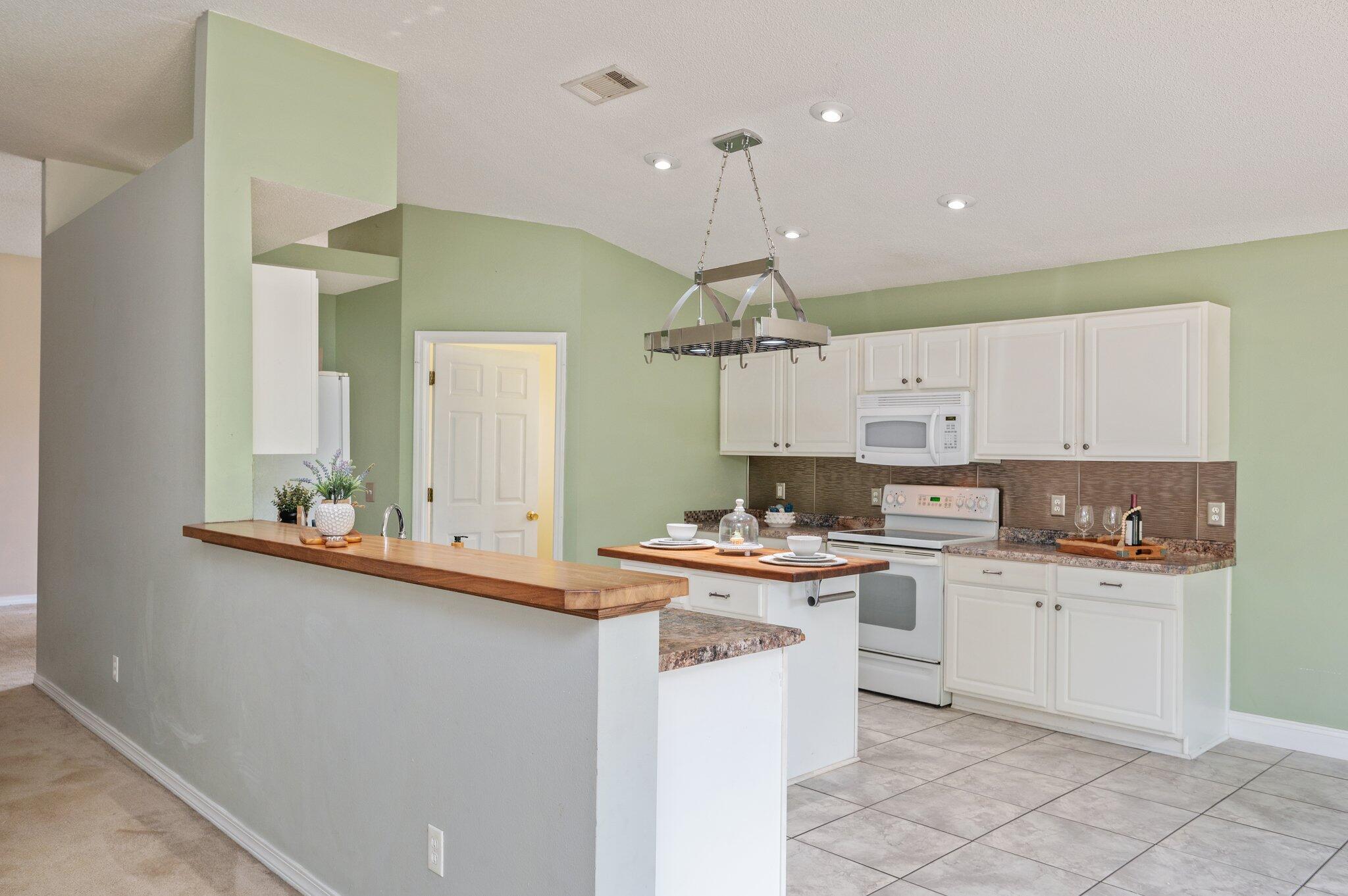 488 Jillian Drive Crestview, FL 32536 - Photo 3 of 29 a kitchen with a sink a stove cabinets and counter space