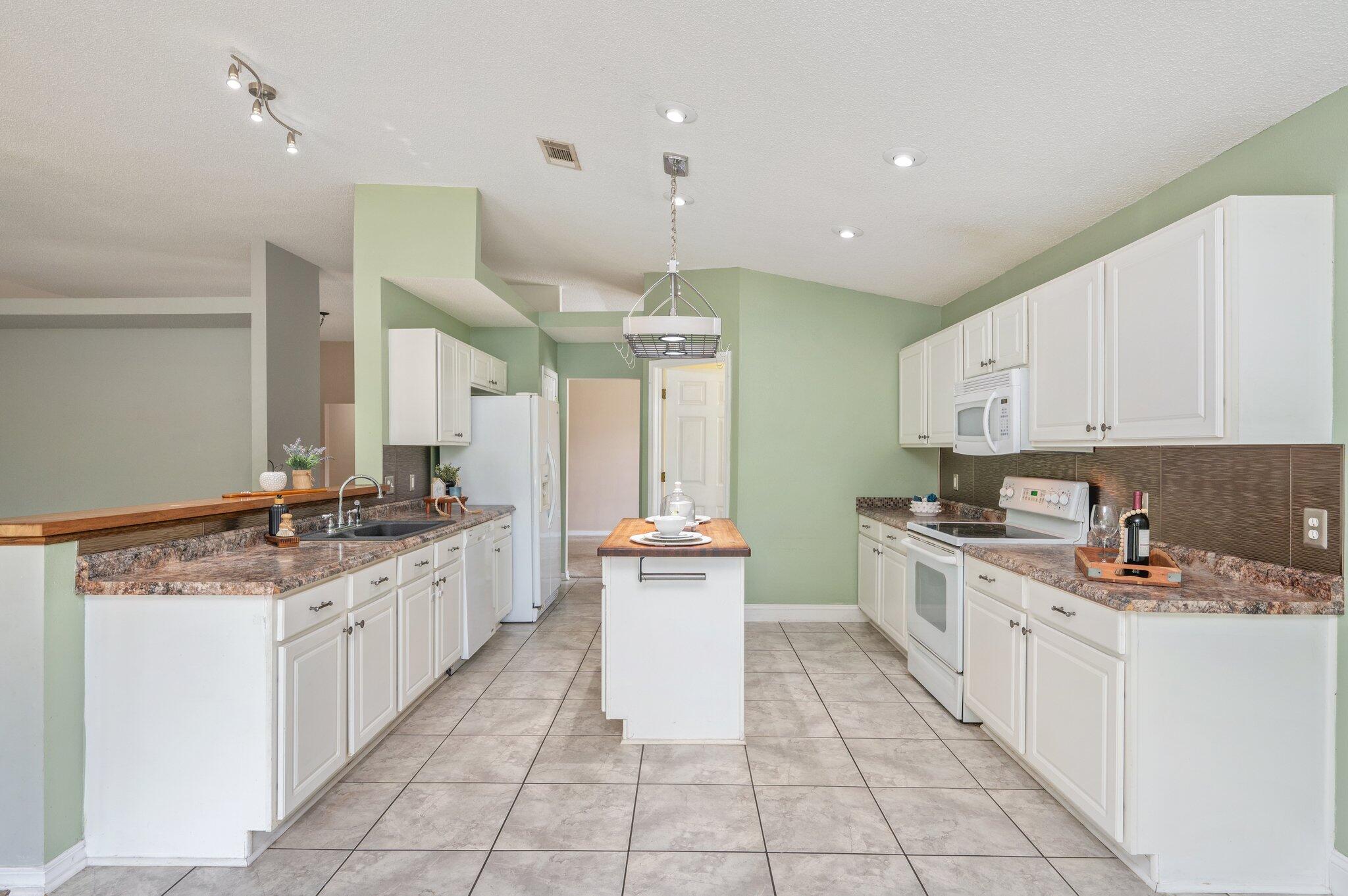488 Jillian Drive Crestview, FL 32536 - Photo 4 of 29 a kitchen with stainless steel appliances a stove top oven