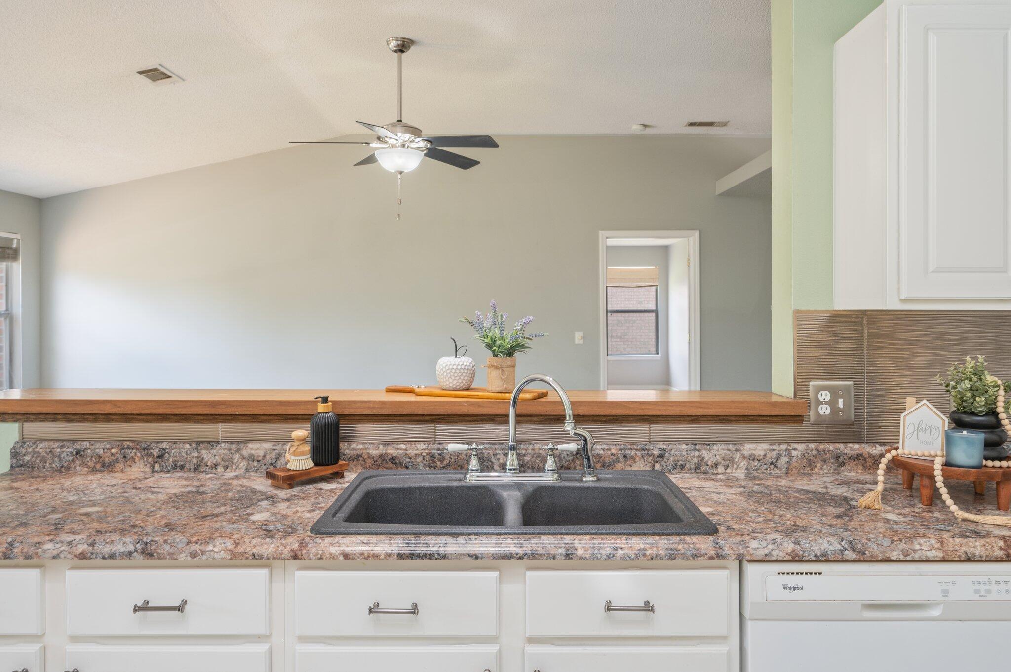 488 Jillian Drive Crestview, FL 32536 - Photo 8 of 29 a kitchen with granite countertop a sink and white cabinets
