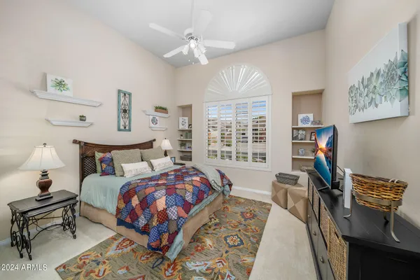 a bed room with a bed and a chair