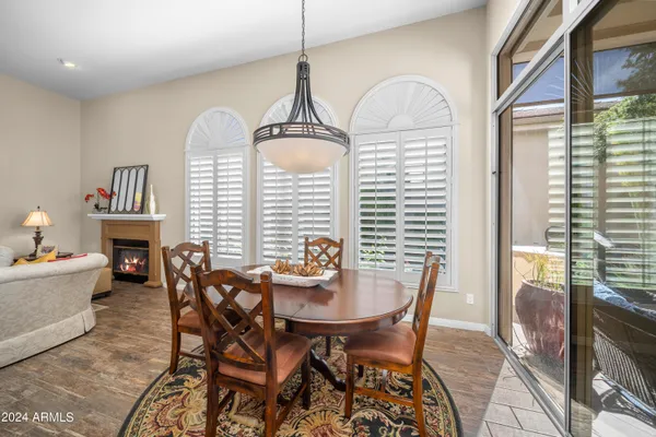 a dining room with furniture a window and a chandelier