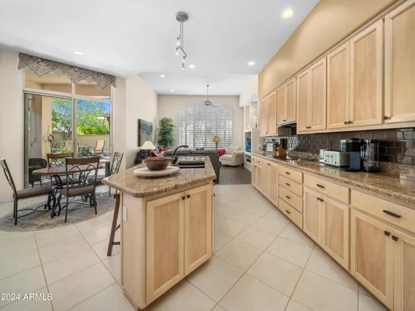 a kitchen with stainless steel appliances granite countertop a stove a sink a oven and a refrigerator
