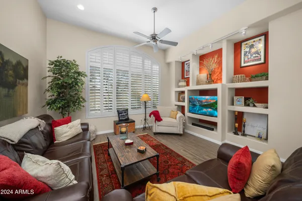 a living room with furniture cabinets and a window