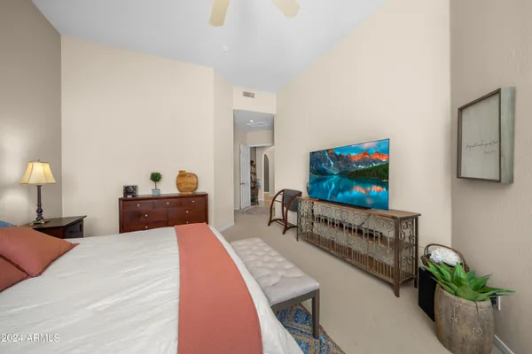 a bedroom with a bed and a flat screen tv