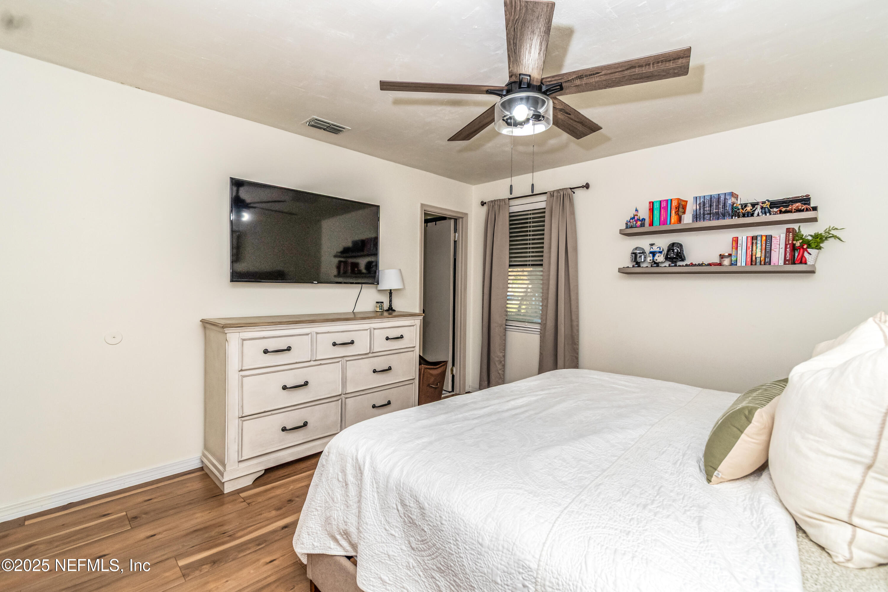 311 North 4th Street Macclenny, FL 32063 - Photo 13 of 35 a bedroom with a bed and a flat screen tv