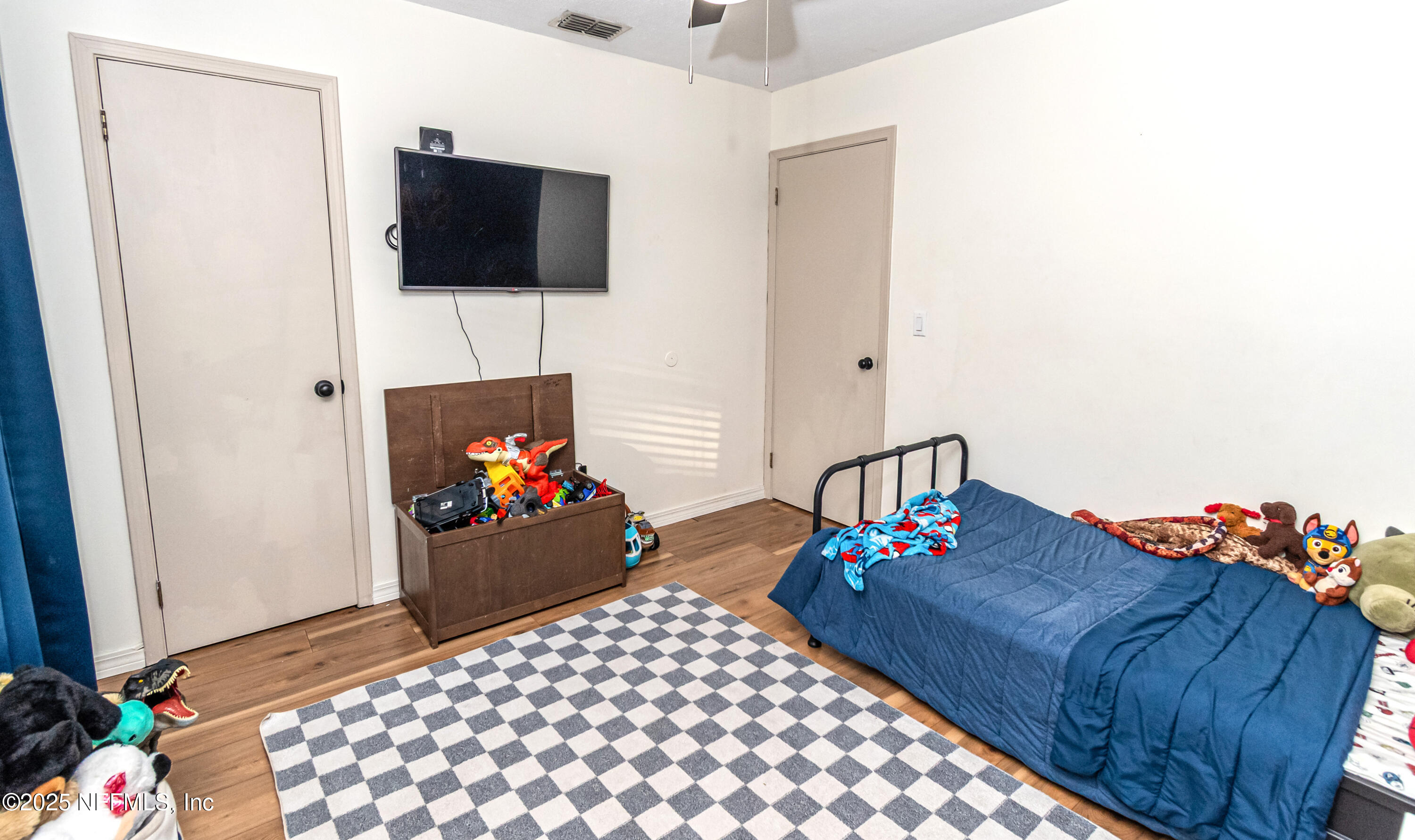 311 North 4th Street Macclenny, FL 32063 - Photo 14 of 35 a bedroom with a bed and a television