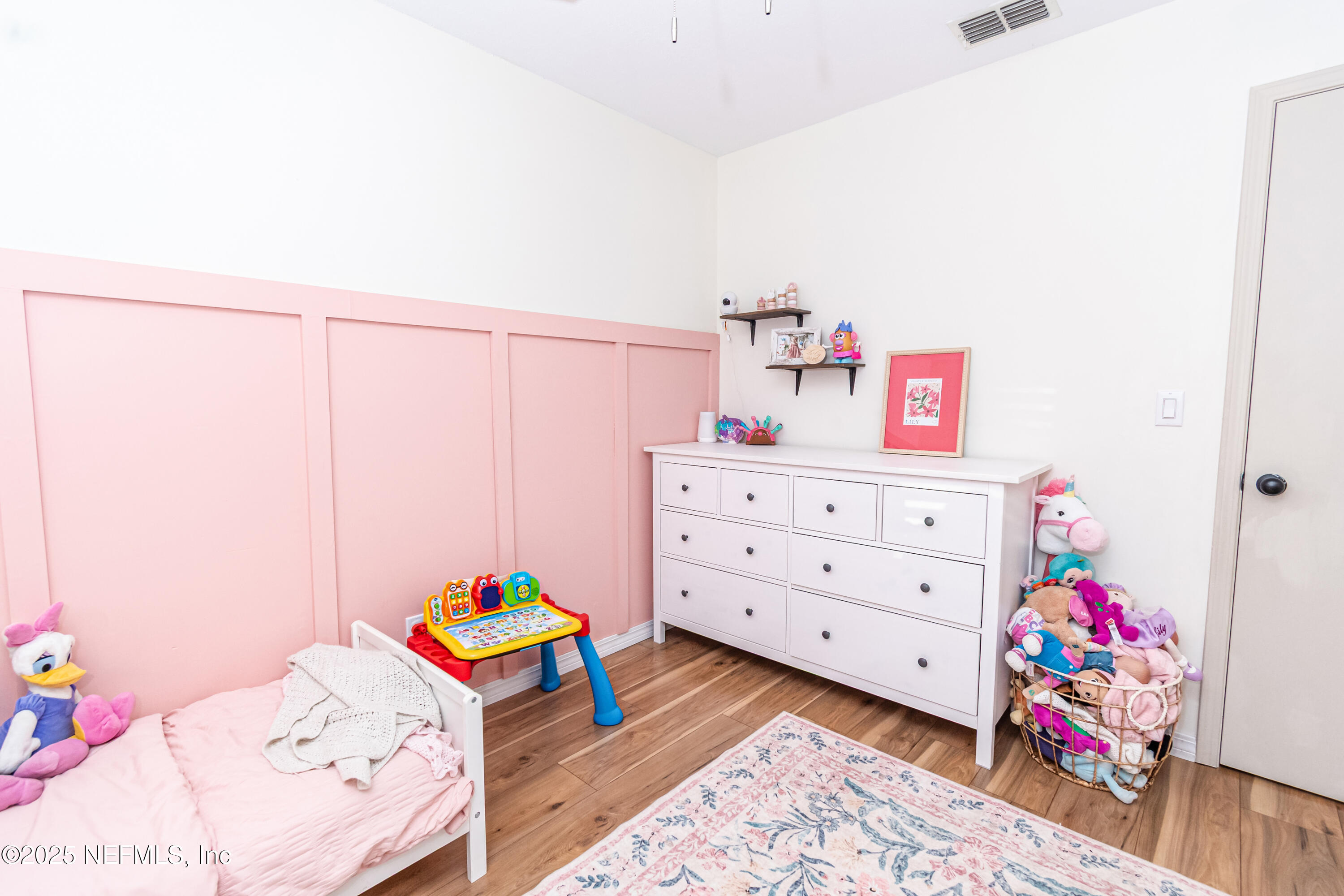 311 North 4th Street Macclenny, FL 32063 - Photo 18 of 35 a bedroom with a bed and a dresser in it