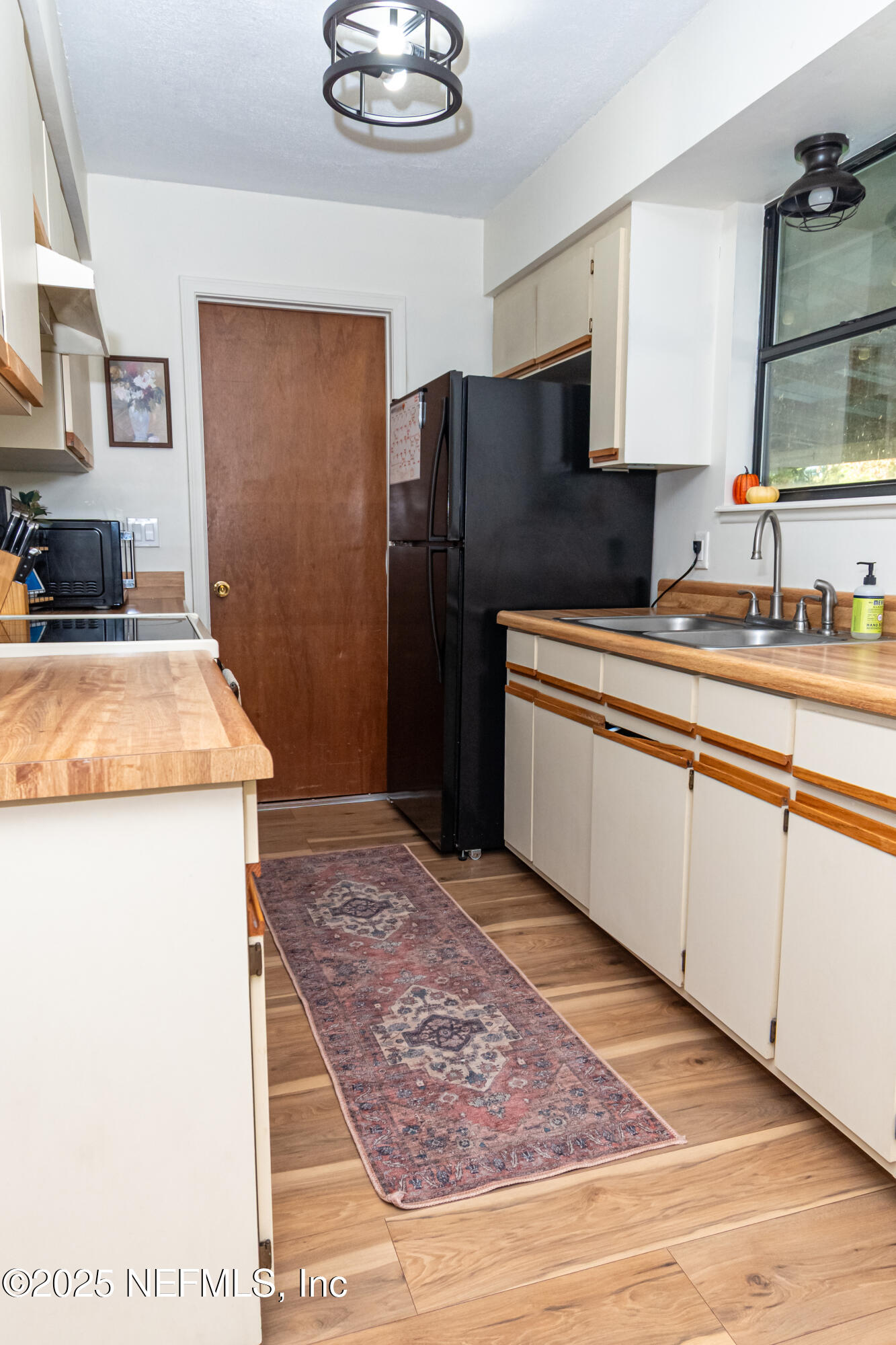 311 North 4th Street Macclenny, FL 32063 - Photo 30 of 35 a kitchen with stainless steel appliances granite countertop a refrigerator sink and stove