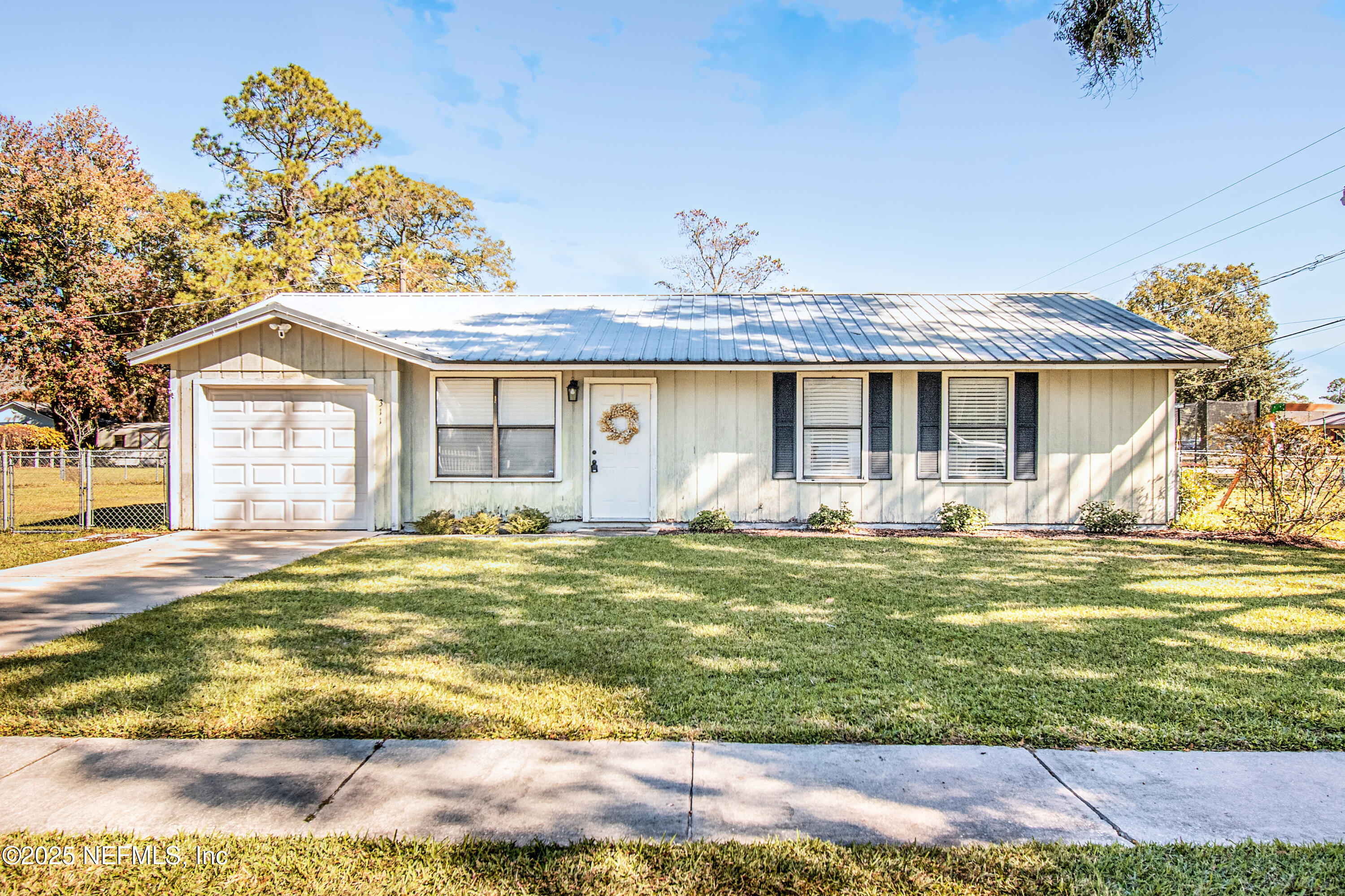311 North 4th Street Macclenny, FL 32063 - Photo 3 of 35 a view of a house with a yard and sitting area