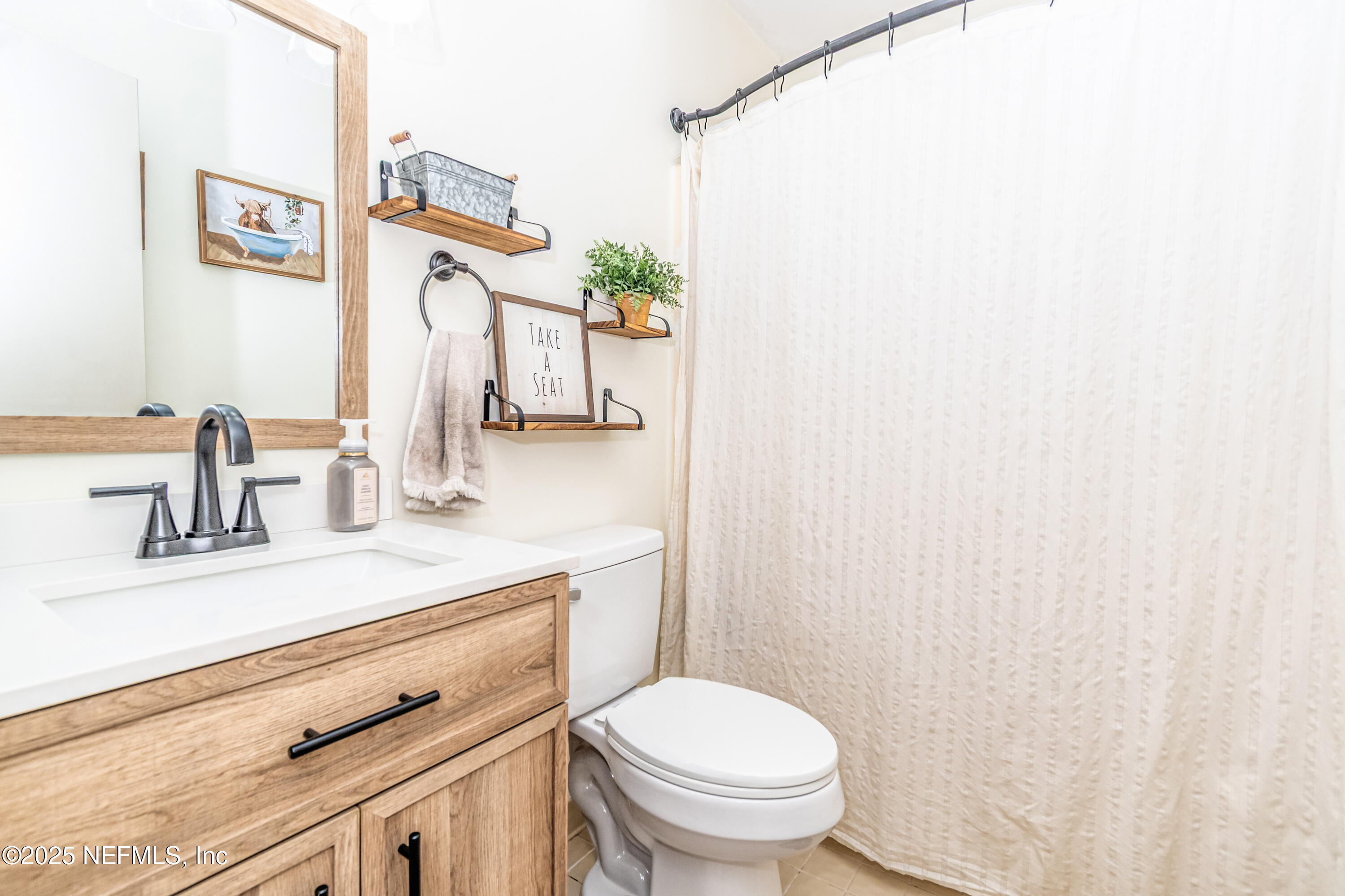 311 North 4th Street Macclenny, FL 32063 - Photo 7 of 35 a bathroom with a granite countertop sink and a toilet