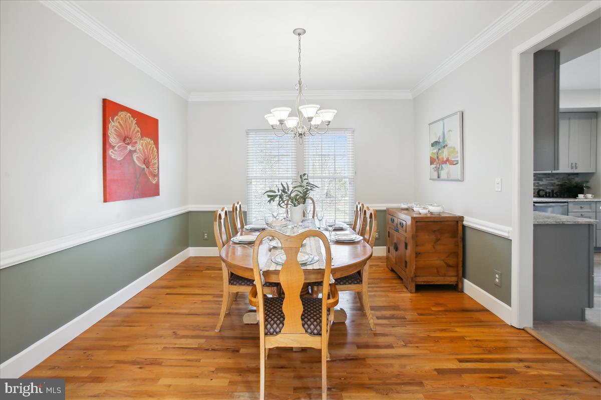 20702 Pomeroy Court Ashburn, VA 20147 - Photo 15 of 60 a view of a dining room with furniture wooden floor and chandelier