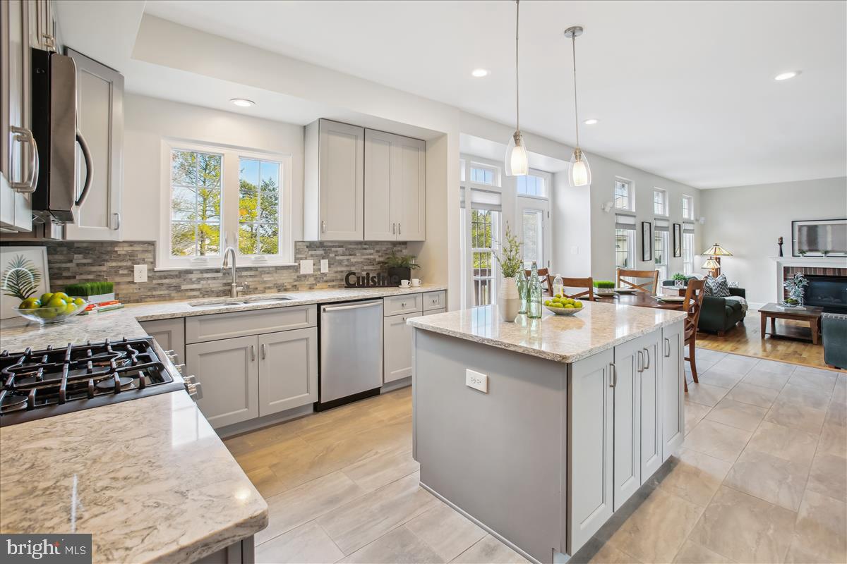 20702 Pomeroy Court Ashburn, VA 20147 - Photo 18 of 60 a kitchen with a sink stove and cabinets