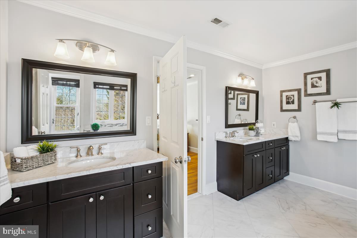 20702 Pomeroy Court Ashburn, VA 20147 - Photo 29 of 60 a spacious bathroom with a granite countertop double vanity sink mirror and bathtub